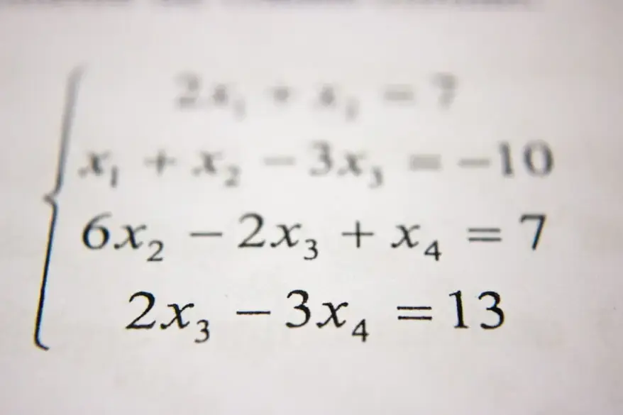 A close up of a paper with a number of equations on it.