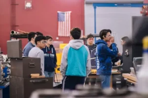 A group of young people standing in a workshop.